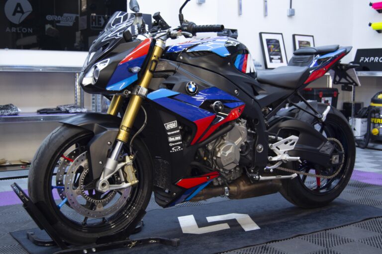 Moto deportiva con vinilo azul, rojo y blanco, vista de lado